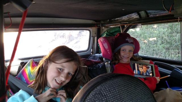 Joleigh and Audrey Mandera take shelter from the cool wind