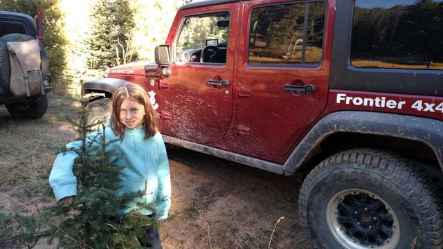 Joleigh gets out at the reclaimed mine site and poses in front of Richard's Jeep