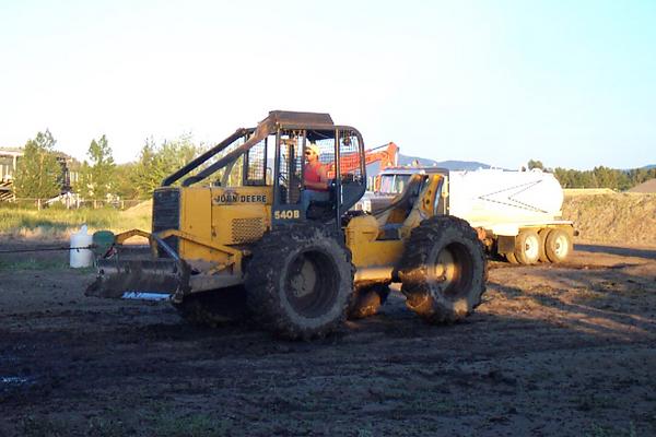 Skidder trying to pull stuck Chevy