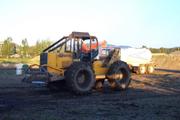 Skidder trying to pull stuck Chevy
