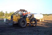 Skidder trying to pull stuck Chevy