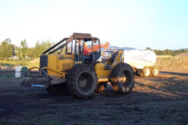 Skidder trying to pull stuck Chevy