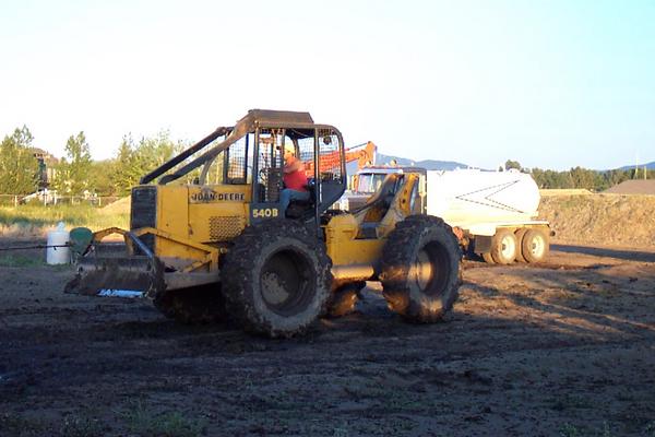 Skidder trying to pull stuck Chevy