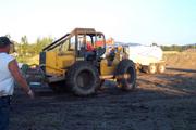 Skidder trying to pull stuck Chevy