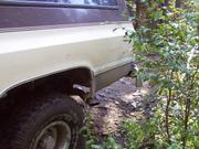 Doug hurts Patti's Suburban and loses a $4 bet in the process when he drops off a rock and peels the rear bumper.
