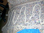 Layers of carpet under pad, glued together with liquid nails, cut all to fit first