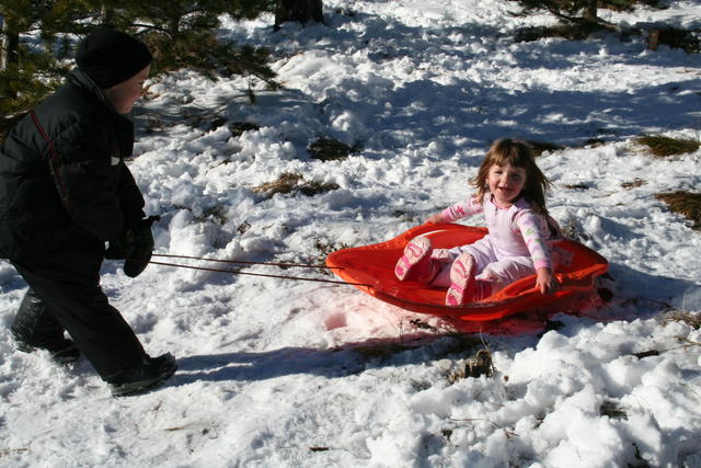 Sam Burton pulls Joleigh Mandera on the sled