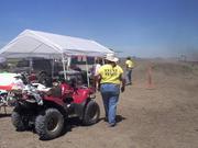 Amanda Eslick walks away from her 4-wheeler, sporting her EVENT STAFF shirt, towards Registration Saturday.